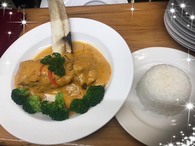 A plate of food with broccoli and rice on a table