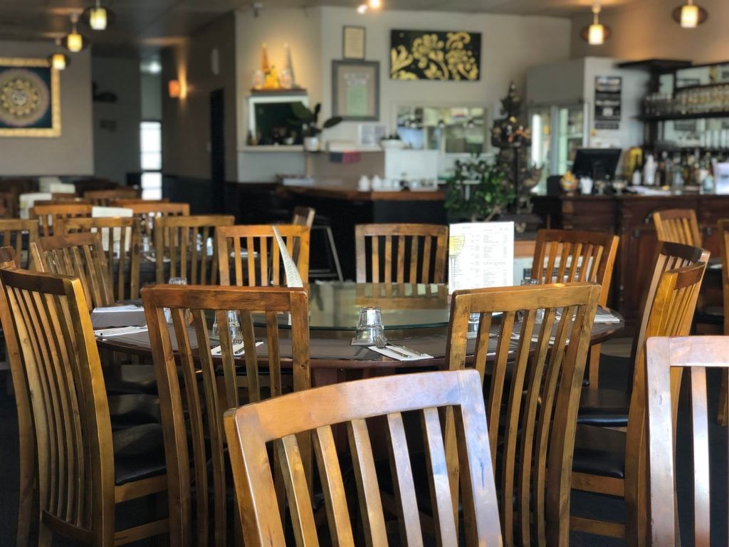 A restaurant filled with wooden tables and chairs.