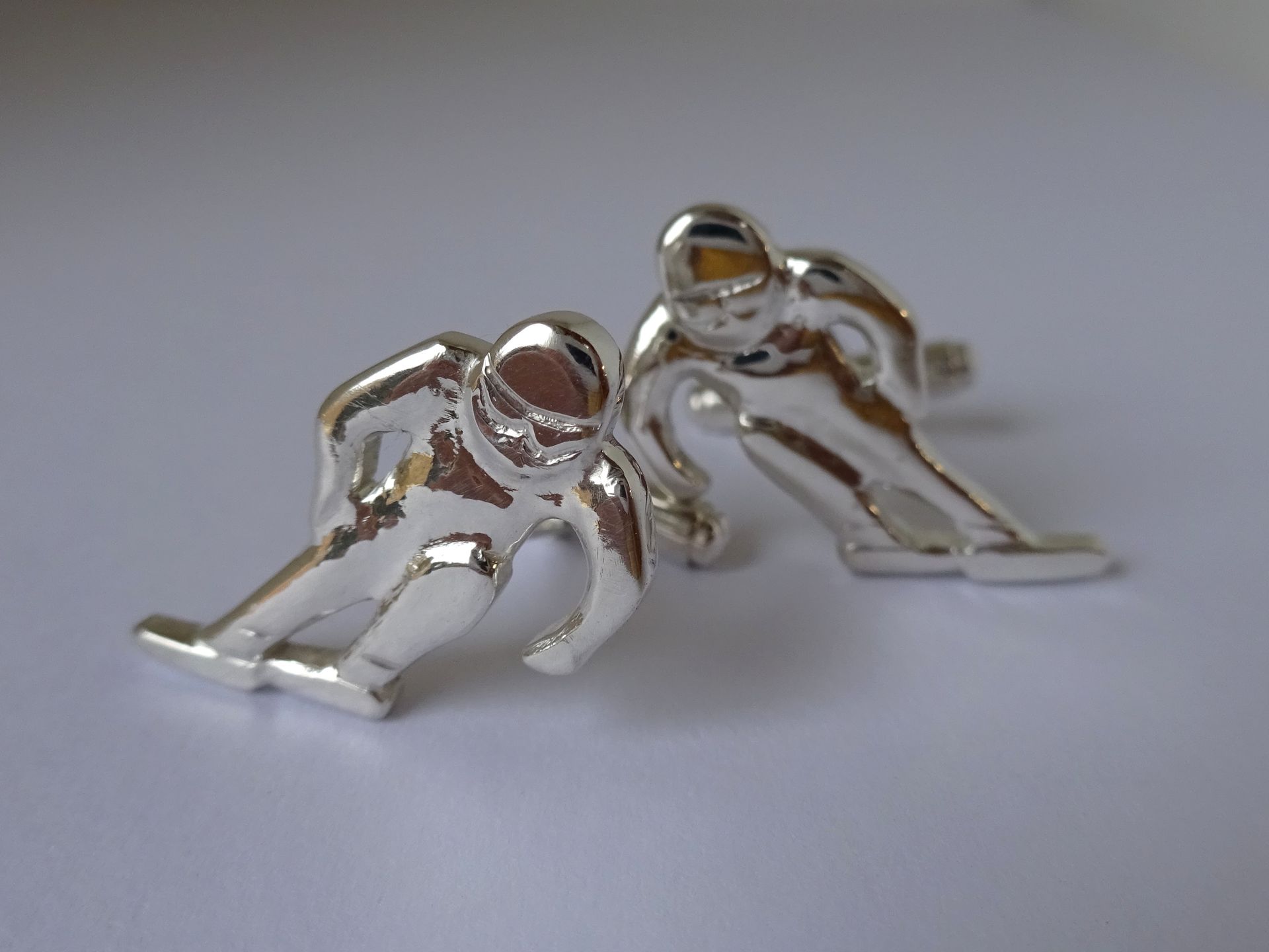 Op maat gemaakte zilveren manchetknopen van skiërs.