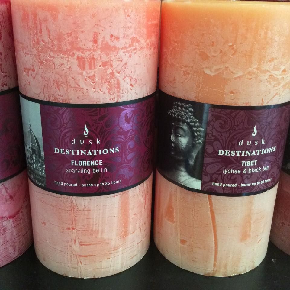 Two Orange Pillar Candles With Destination Labels — Enterprise Electrics NT Pty Ltd in Tennant Creek, NT