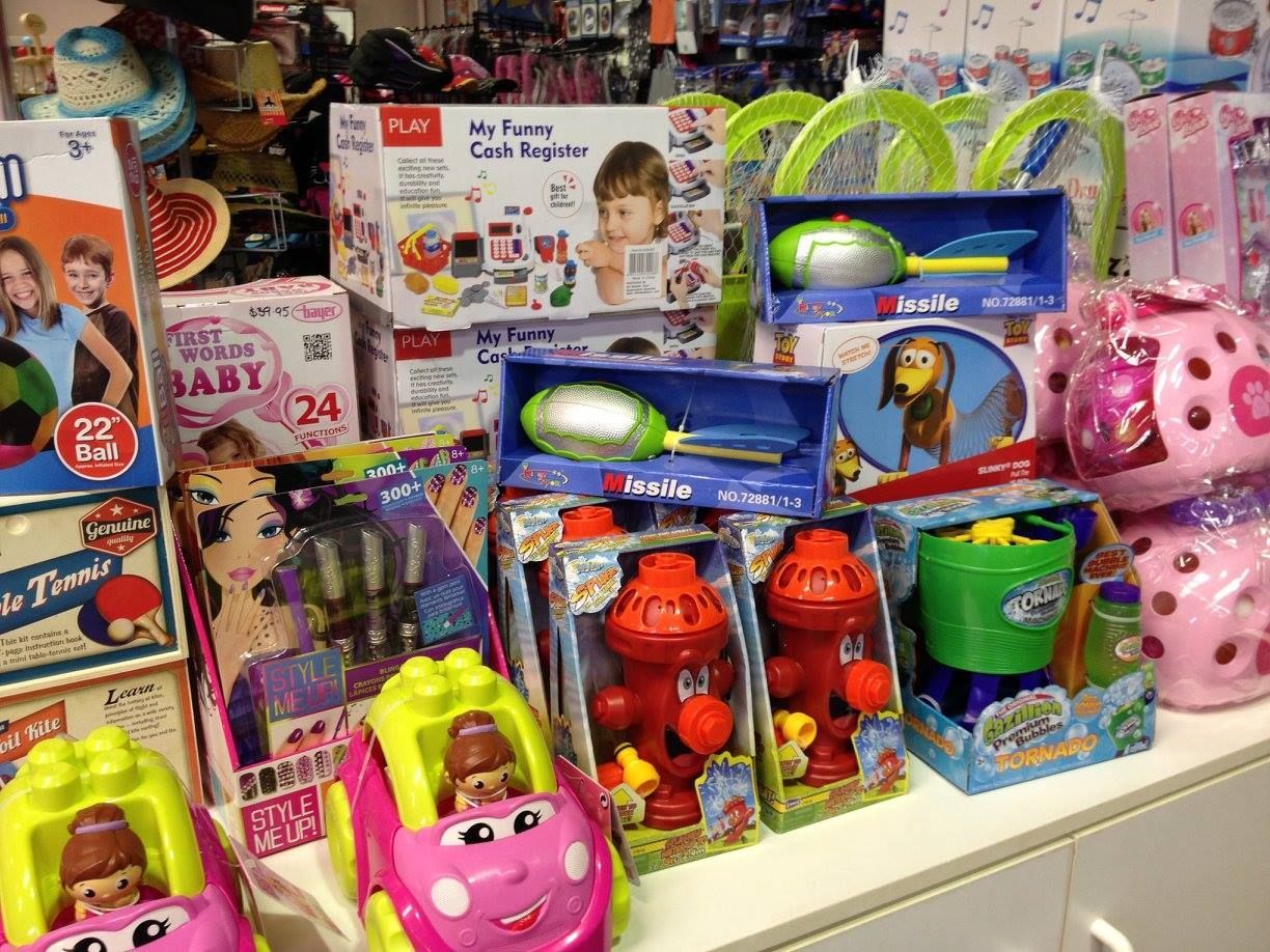 Toys Displayed on a Store Shelf, Including Cars, Fire Hydrants, Water Guns, and Pink Piggy Banks — Enterprise Electrics NT Pty Ltd in Tennant Creek, NT
