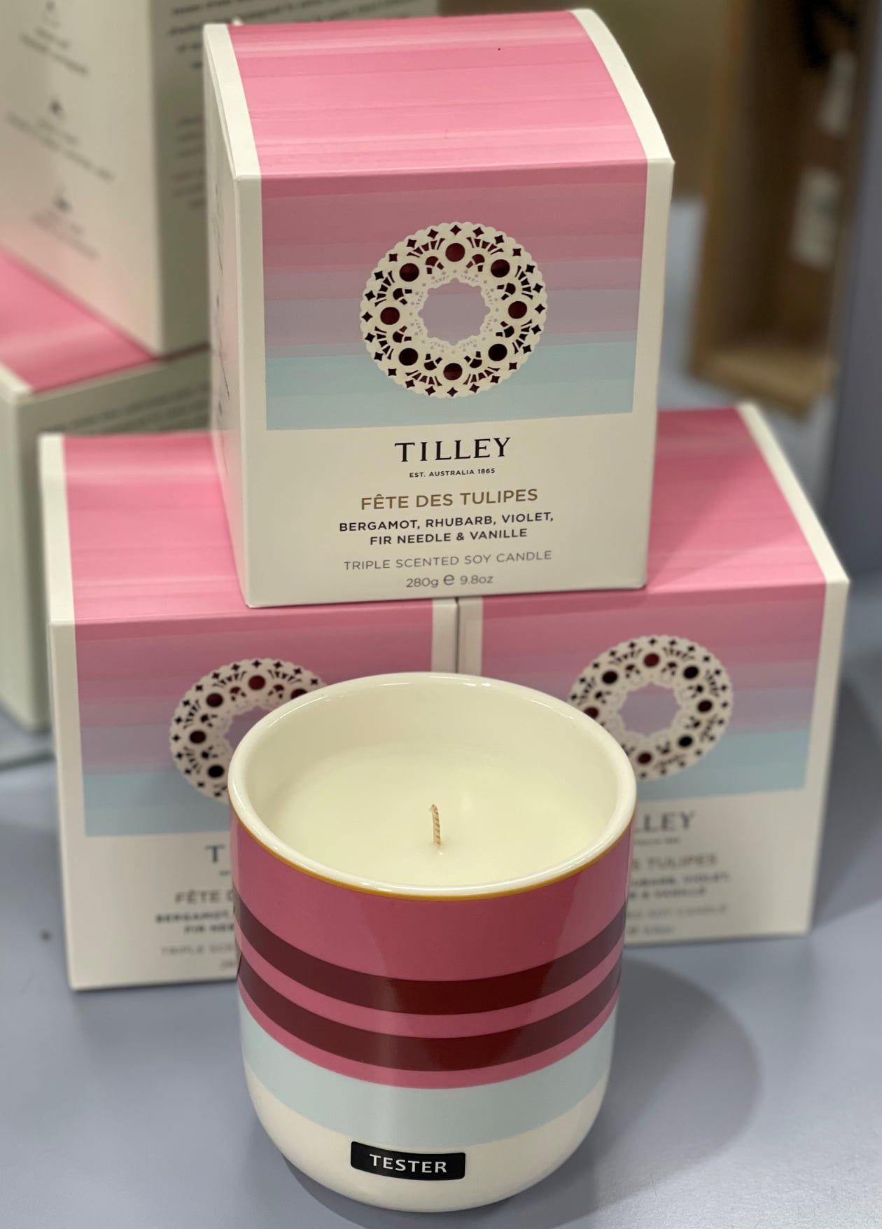 Candle in Pink and Red Striped Holder, in Front of Boxes — Enterprise Electrics NT Pty Ltd in Tennant Creek, NT