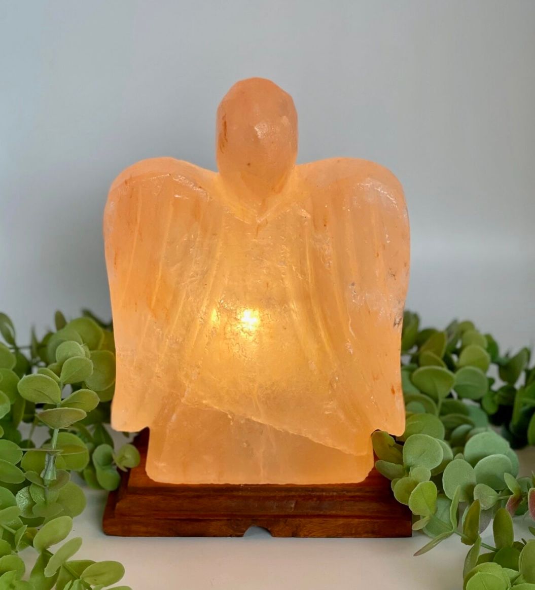 a Lit, Orange Angel Candle Lamp on a Wooden Base — Enterprise Electrics NT Pty Ltd in Tennant Creek, NT