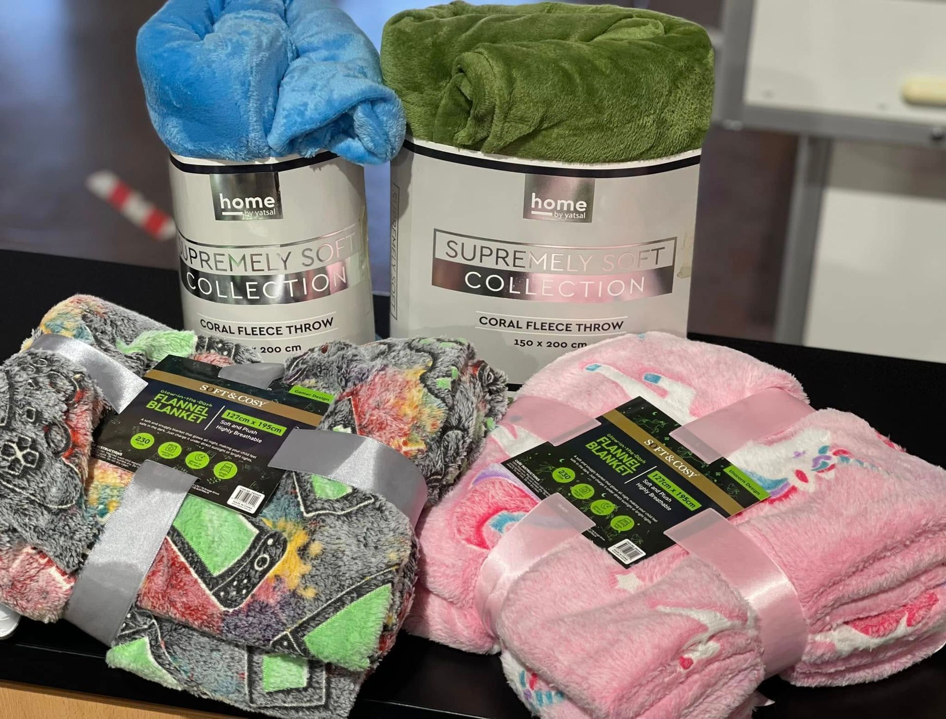 Soft Blankets in Various Colours, Some Rolled and Displayed in Containers — Enterprise Electrics NT Pty Ltd in Tennant Creek, NT
