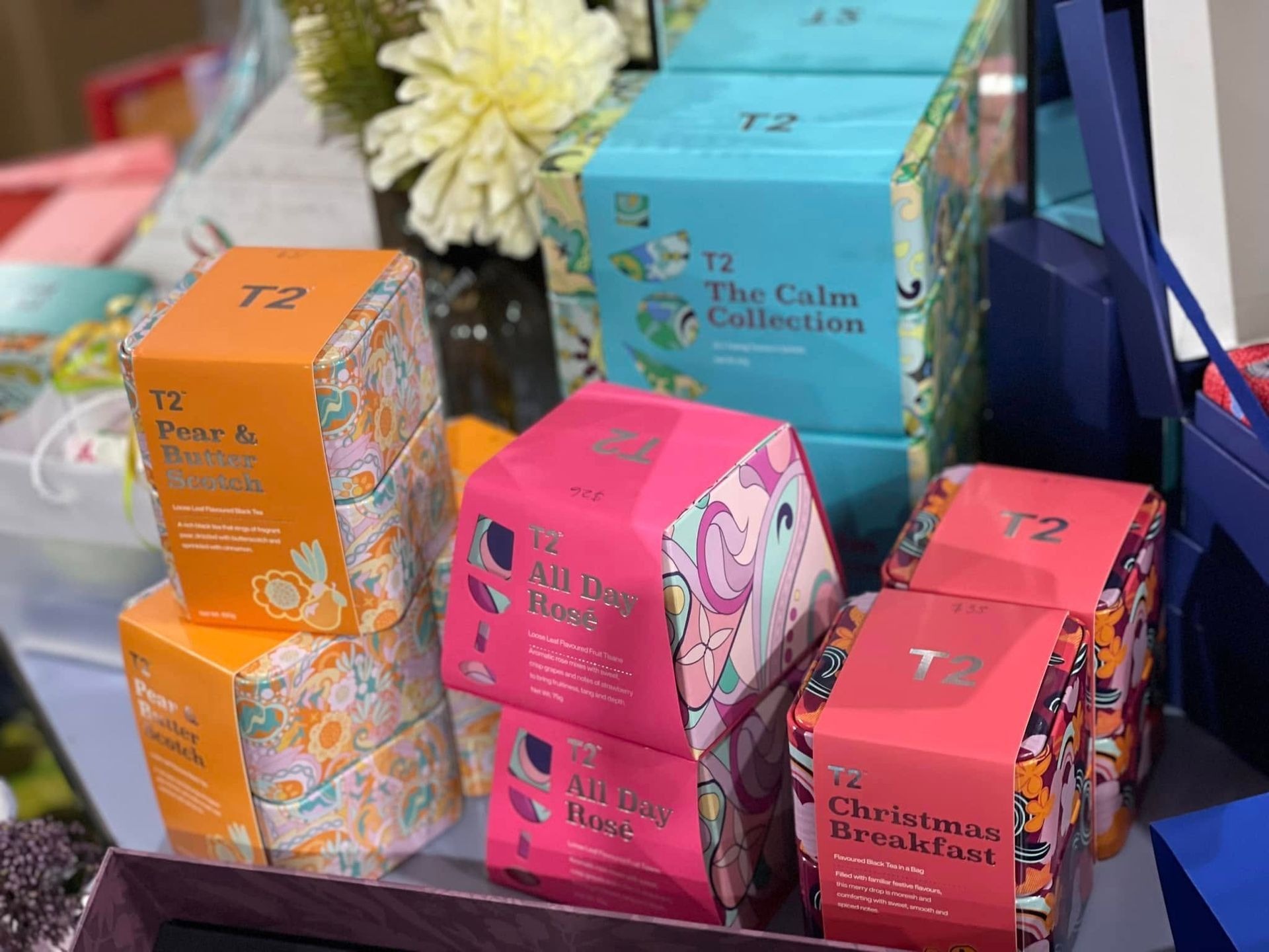 Stacked Tea Boxes Orange, Pink, Blue With the T2 Logo — Enterprise Electrics NT Pty Ltd in Tennant Creek, NT