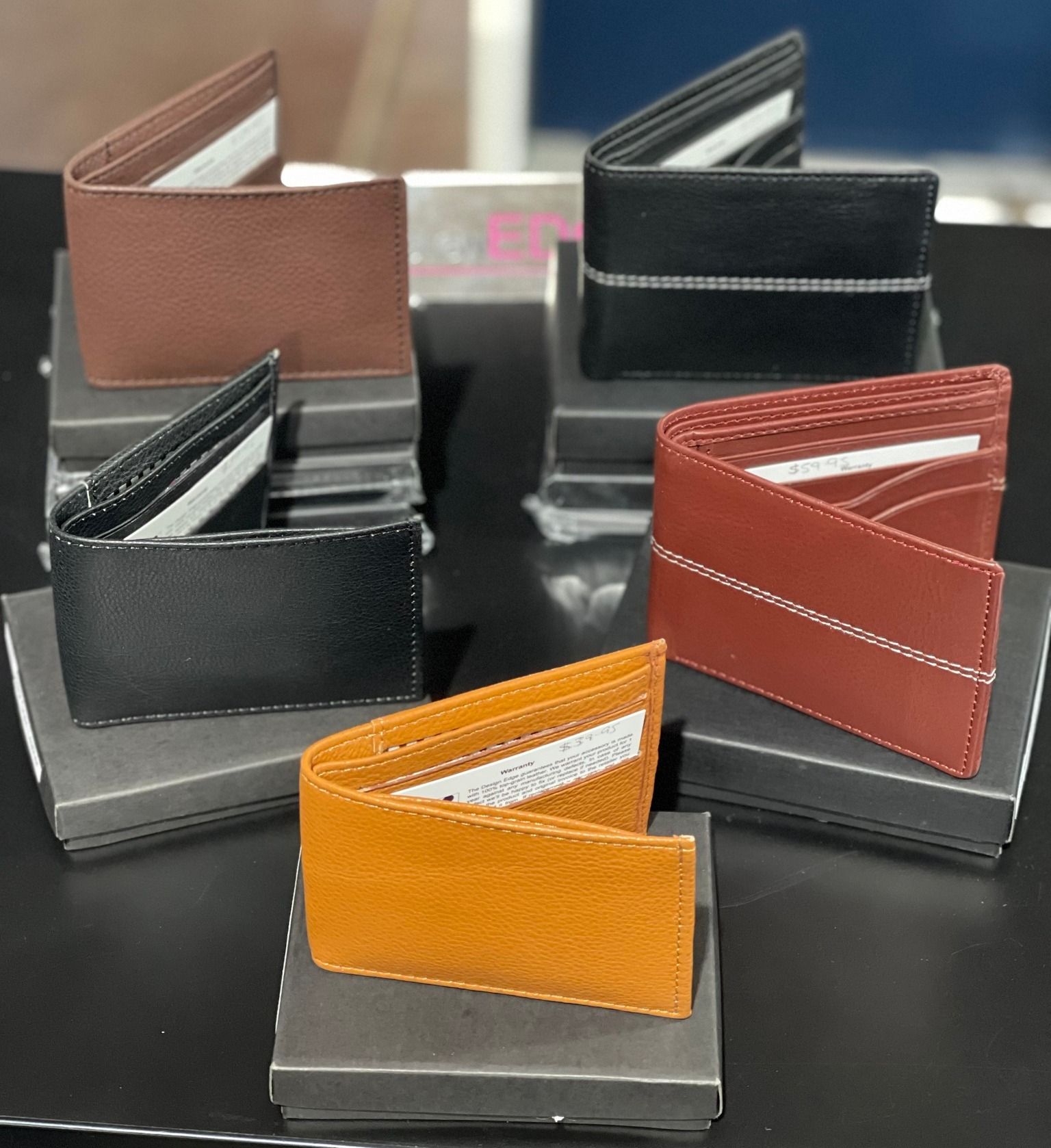 Six Leather Wallets in Various Colours Displayed on Boxes — Enterprise Electrics NT Pty Ltd in Tennant Creek, NT
