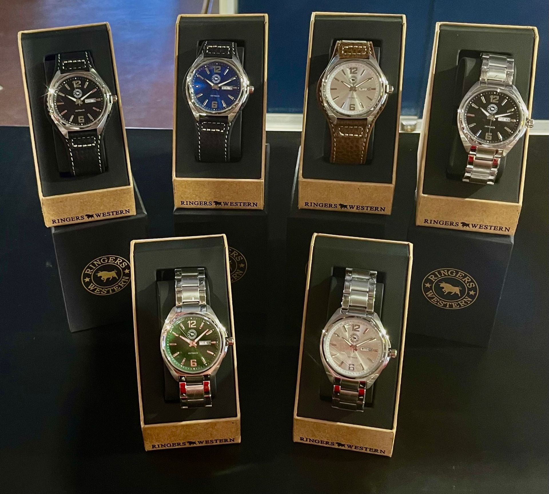 Seven Watches Displayed in Individual Boxes on a Dark Surface — Enterprise Electrics NT Pty Ltd in Tennant Creek, NT
