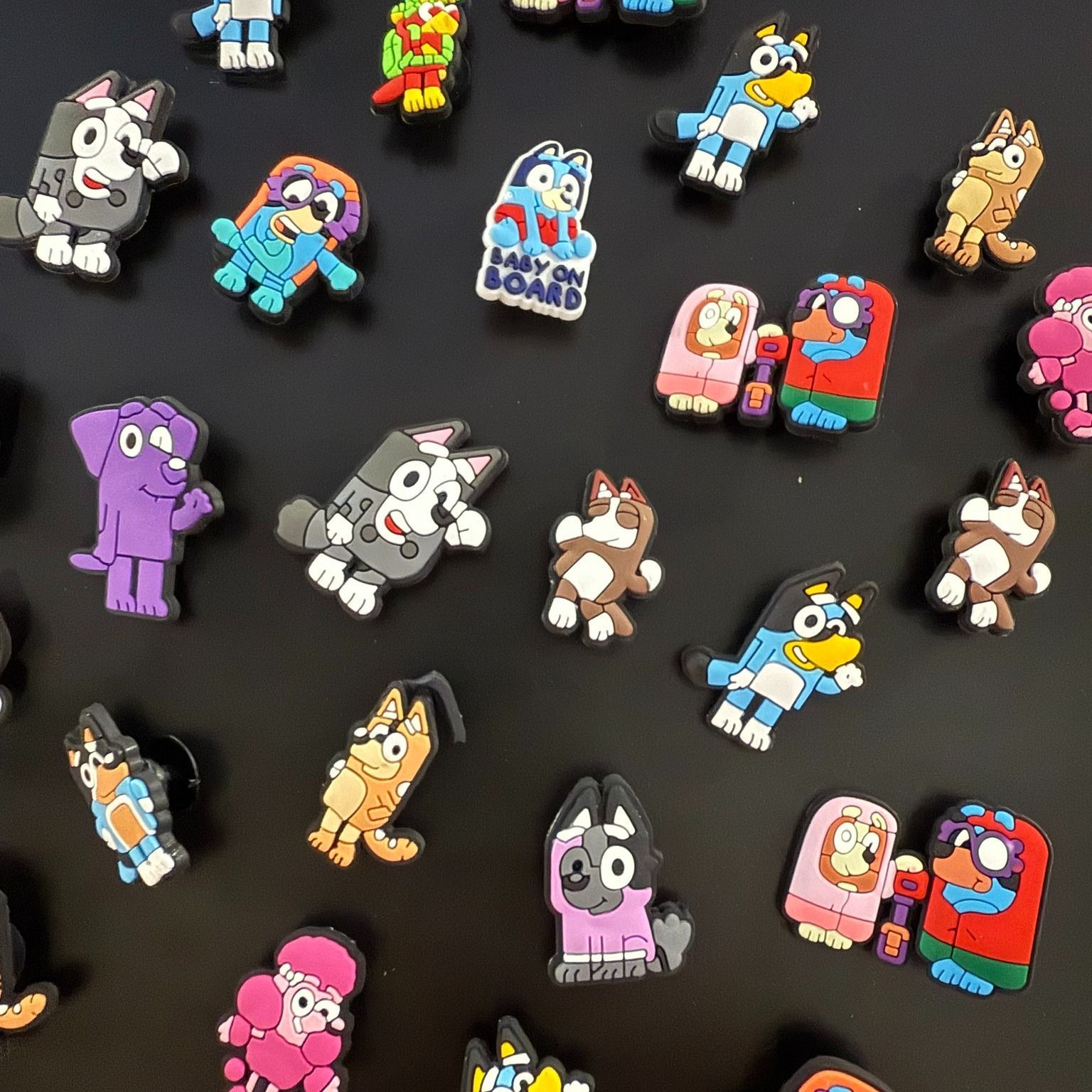 Bluey and Bingo Shoe Charms on a Black Background — Enterprise Electrics NT Pty Ltd in Tennant Creek, NT