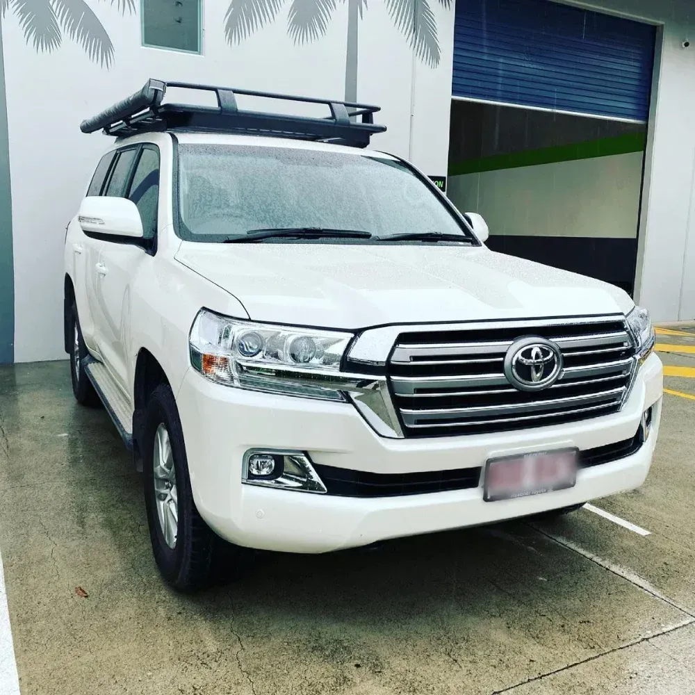 White Toyota Land Cruiser Suv With Roof Rack Parked in Front of a Building — All Coast Auto Solutions in Noosaville, QLD