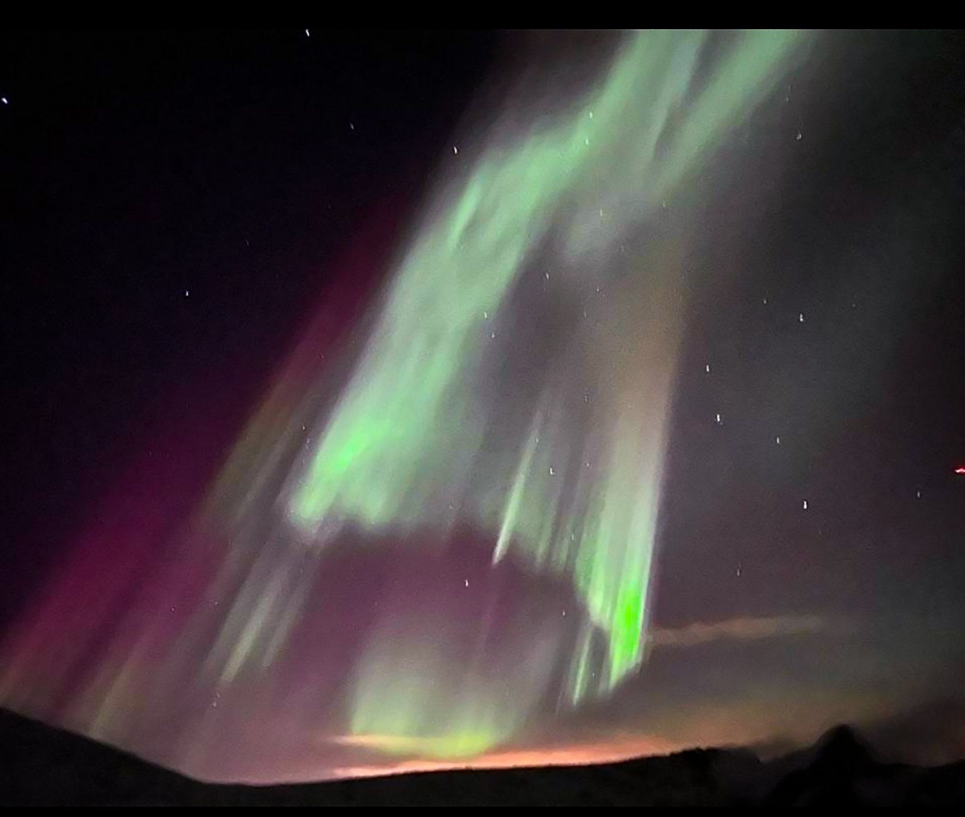 The aurora borealis is dancing in the night sky