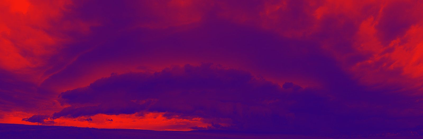 A purple and red background with a few clouds in it