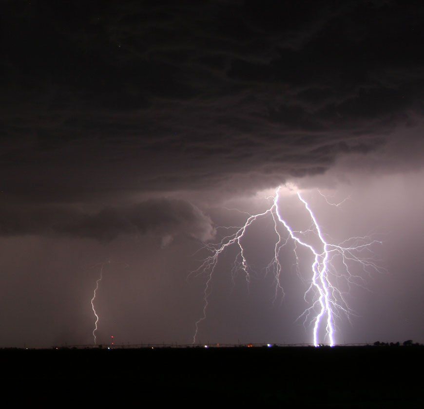 There is a lot of lightning in the sky at night.