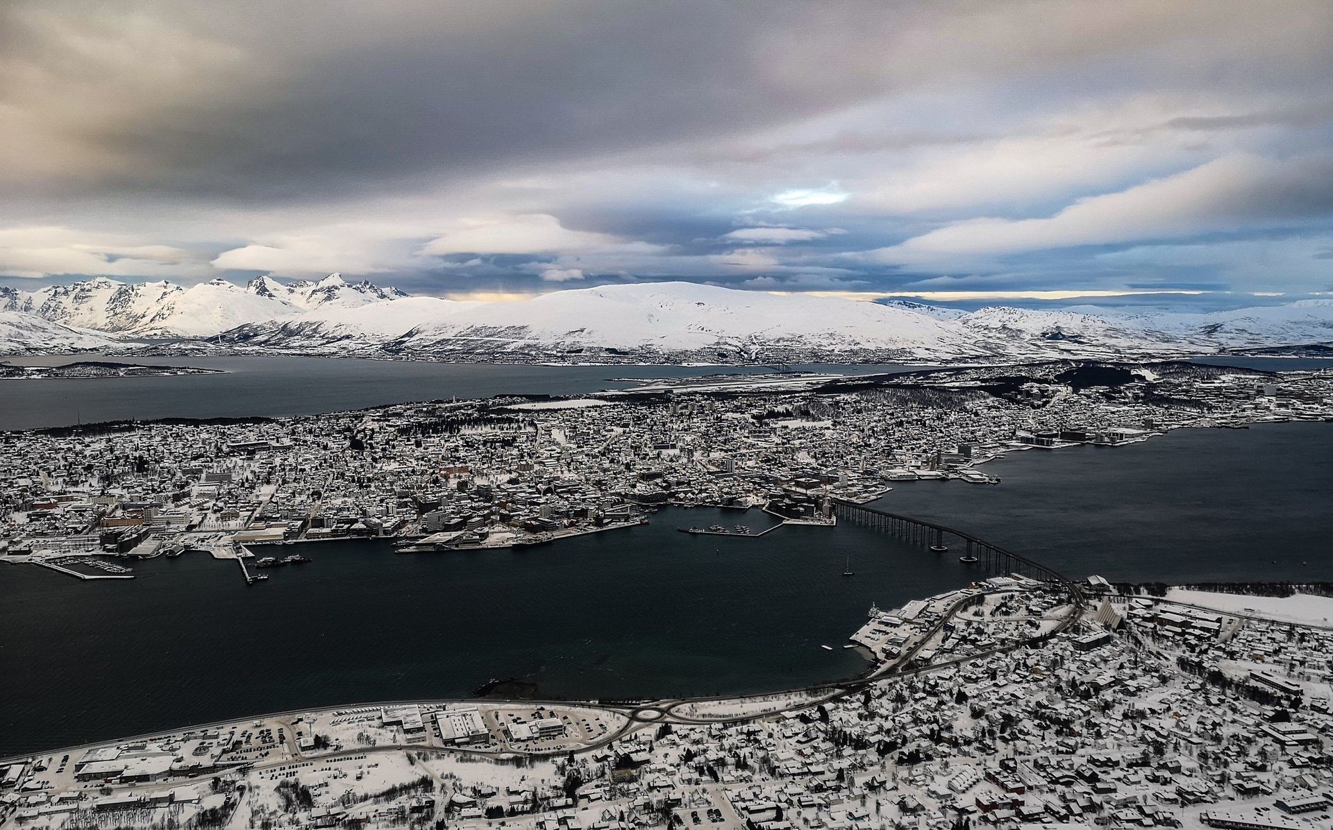An aerial view of a city surrounded by snow and water