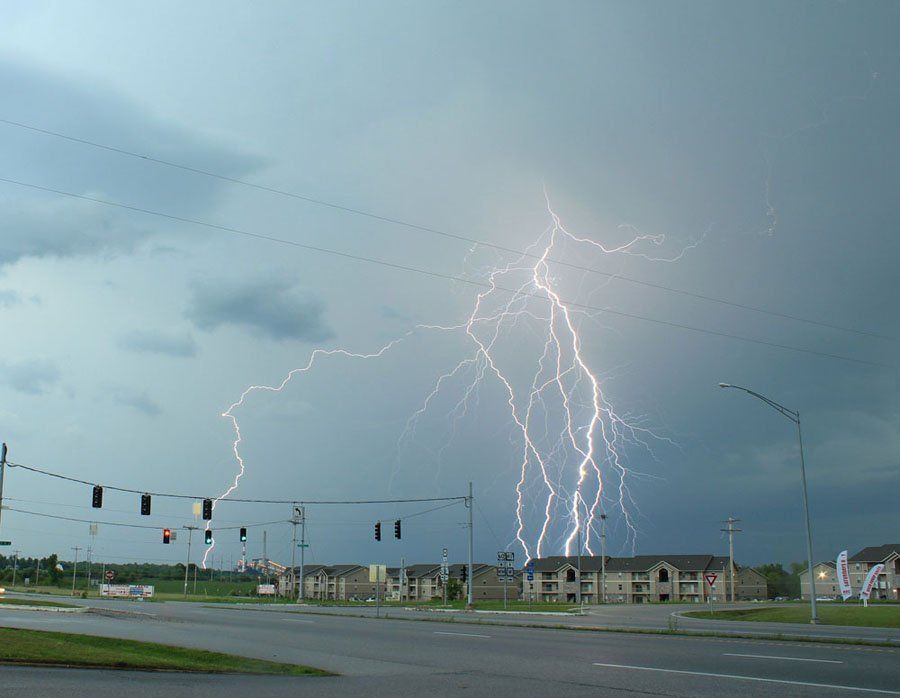Lightning strikes in the sky over a street