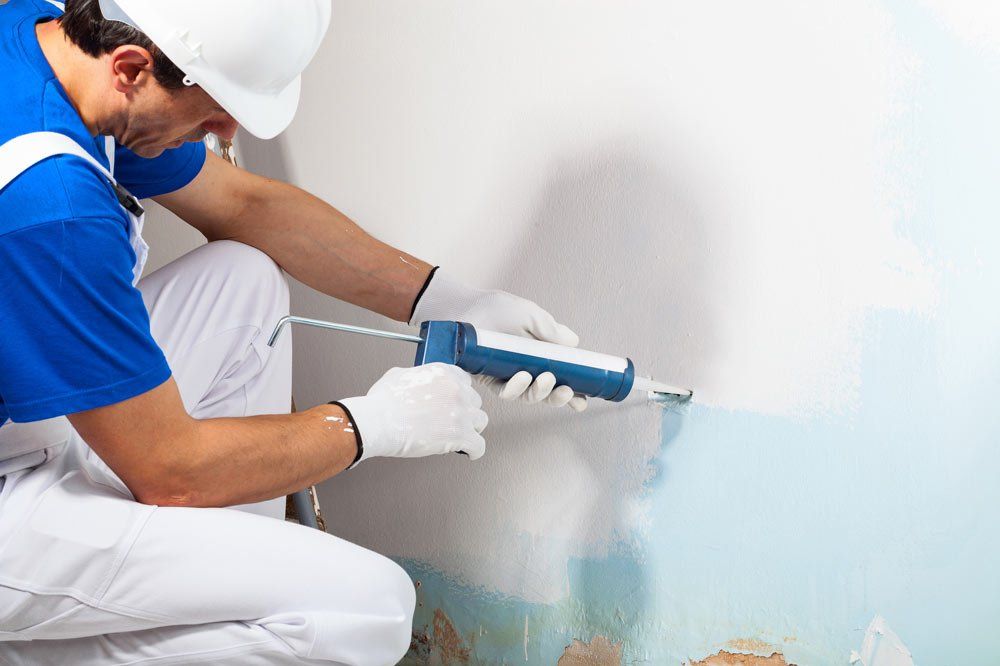 Worker Holding Caulking — Bolingbrook, IL — A & D Quality Painting
