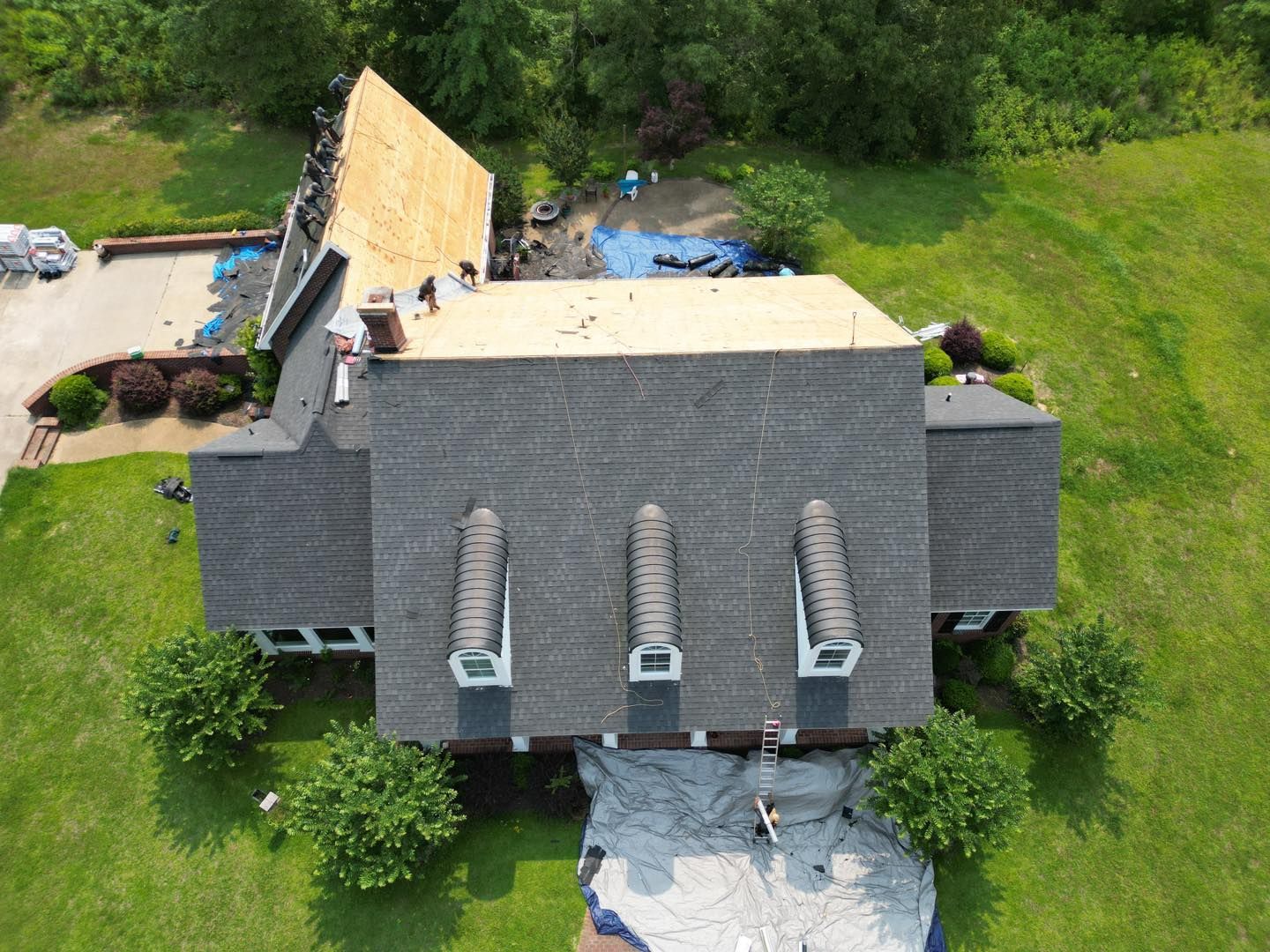An aerial view of a house with a new roof.