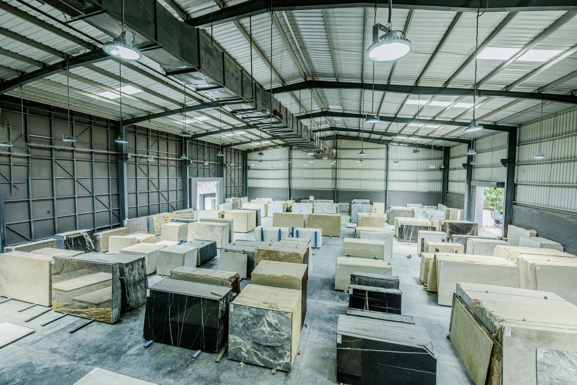 Interior of a warehouse set up as a paintball arena. Gray and tan blocks create barriers.