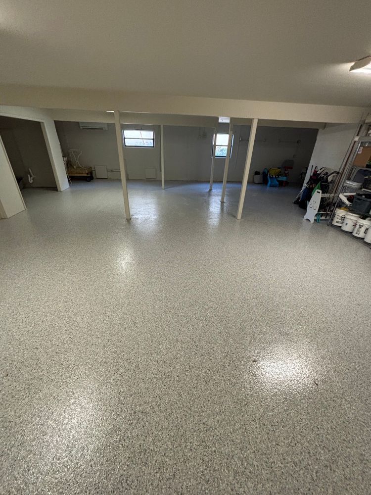 A large empty basement with a white floor.