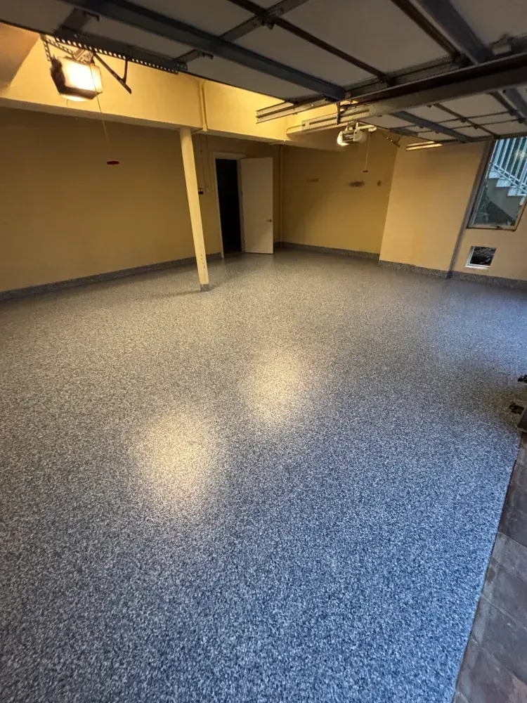 A garage with a concrete floor and a door.