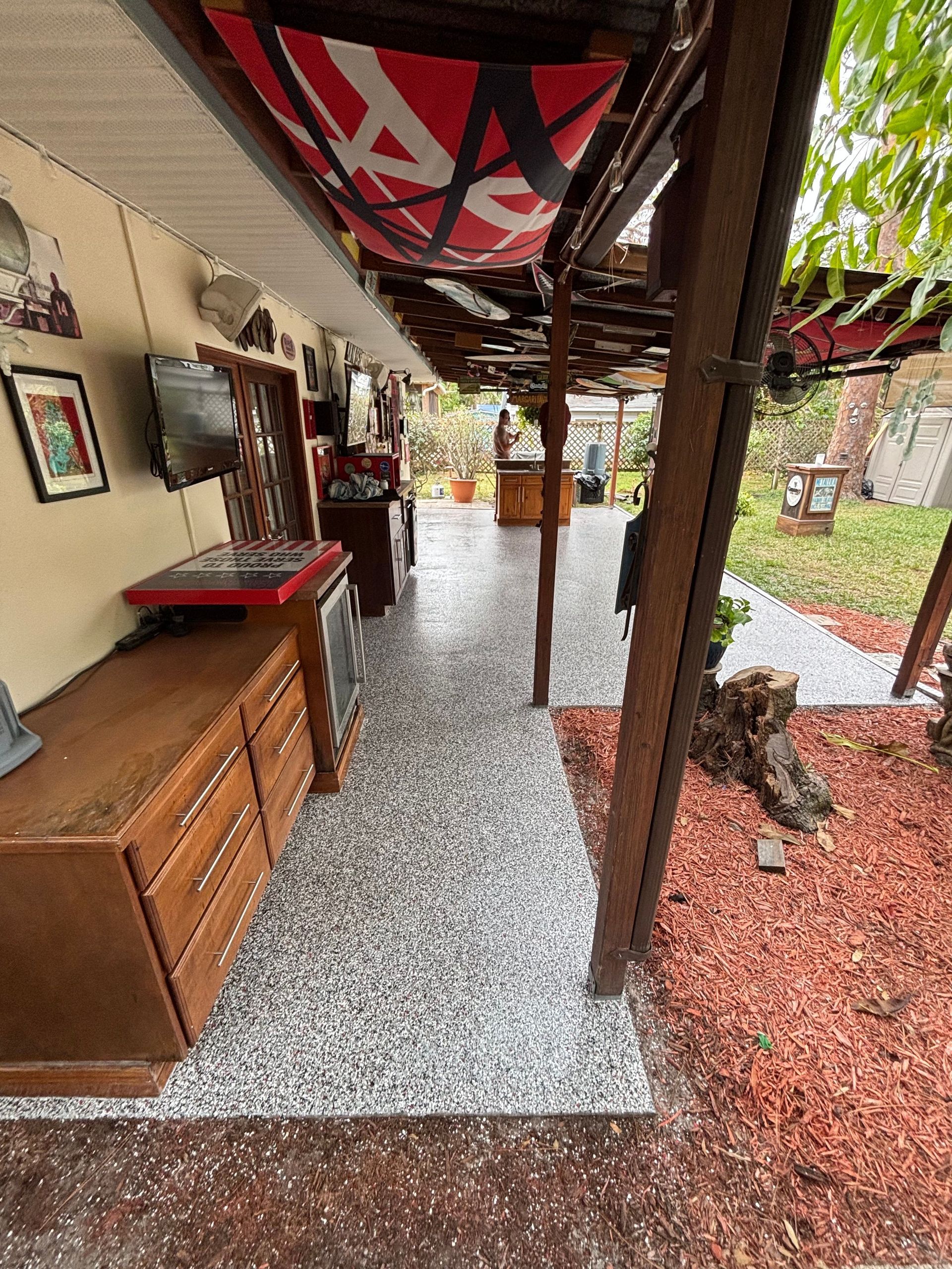 A patio with a covered area and a table and chairs under a canopy.