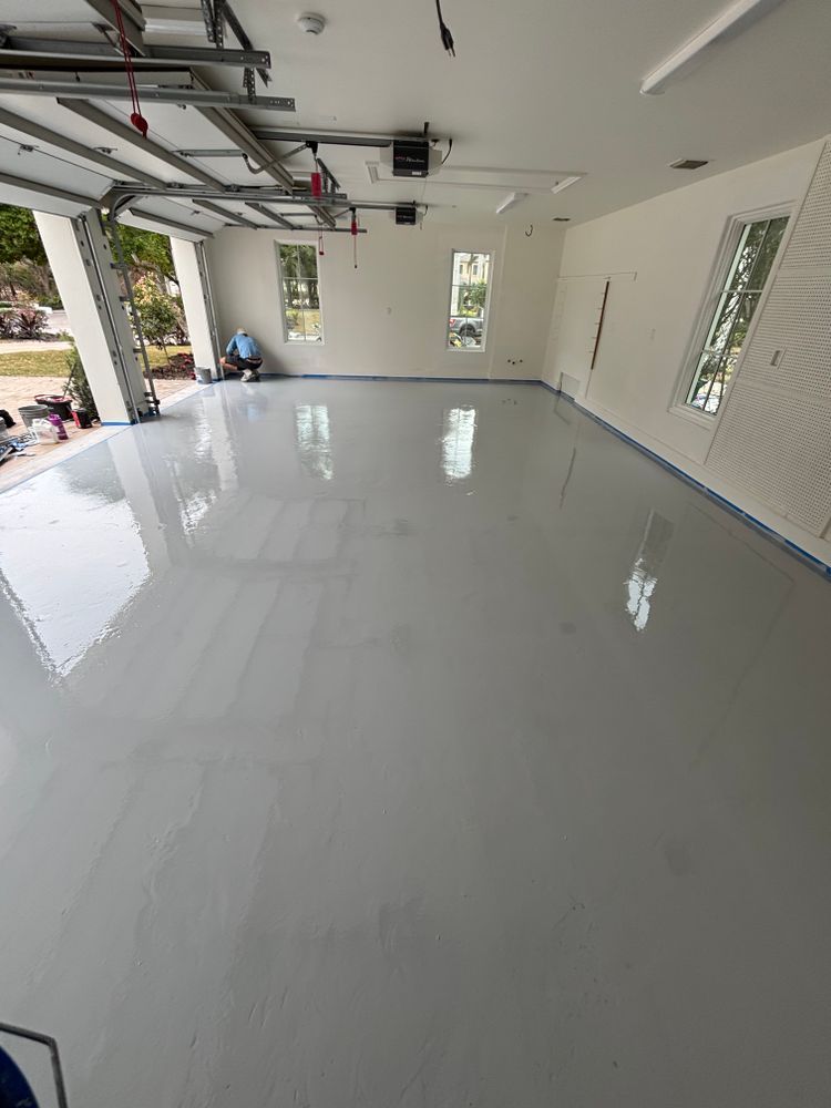 A garage with a gray floor and white walls.