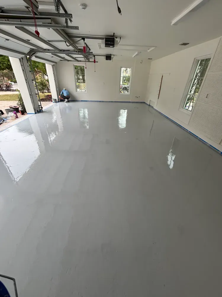 A large garage with a gray floor and white walls.