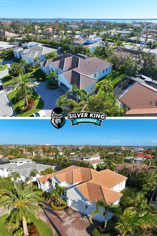 An aerial view of a house in a residential area surrounded by palm trees.