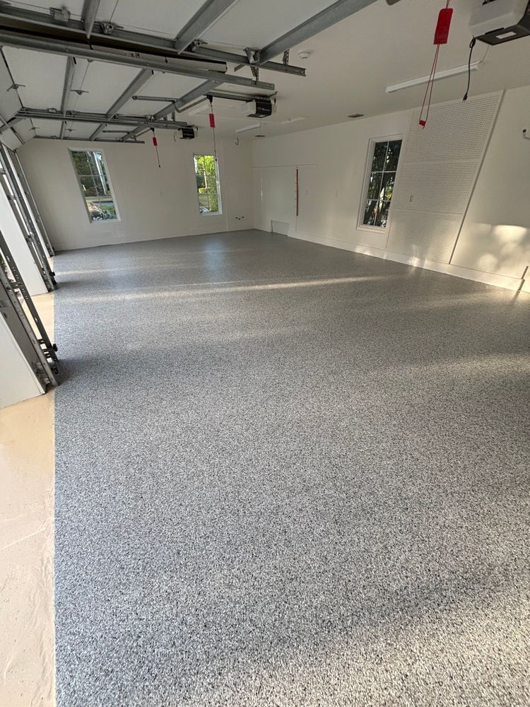 A garage with a gray floor and white walls.