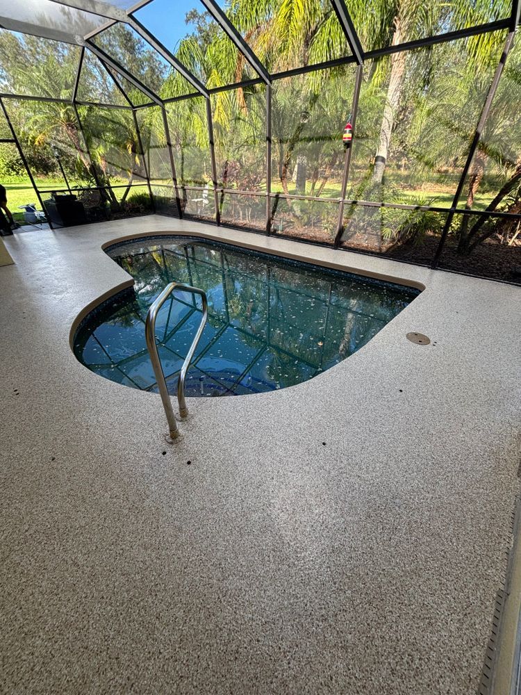 A swimming pool in a screened in area with a staircase leading to it.