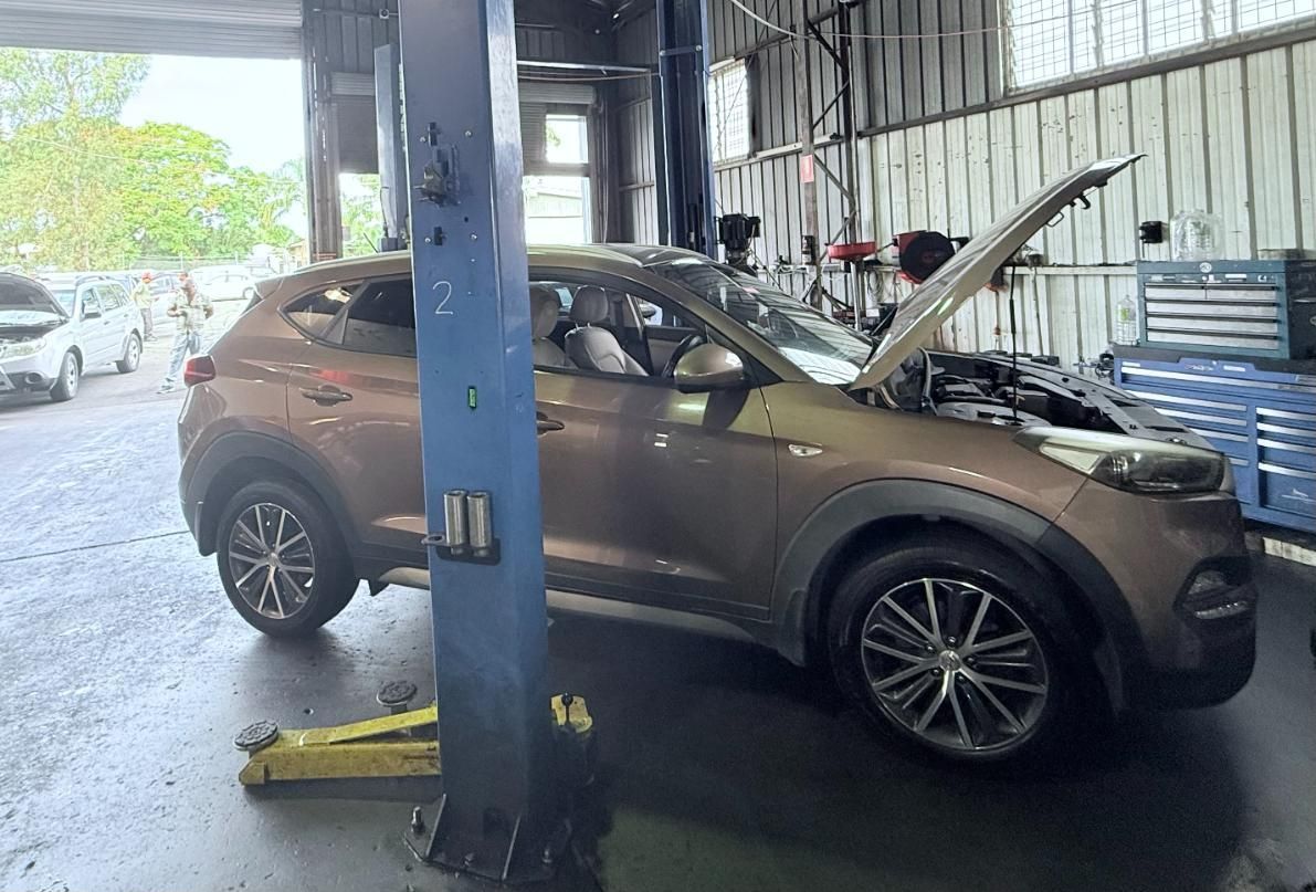 A Car is Sitting on a Lift in a Garage With Its Hood Open — ABIV Automotive In Richlands, QLD
