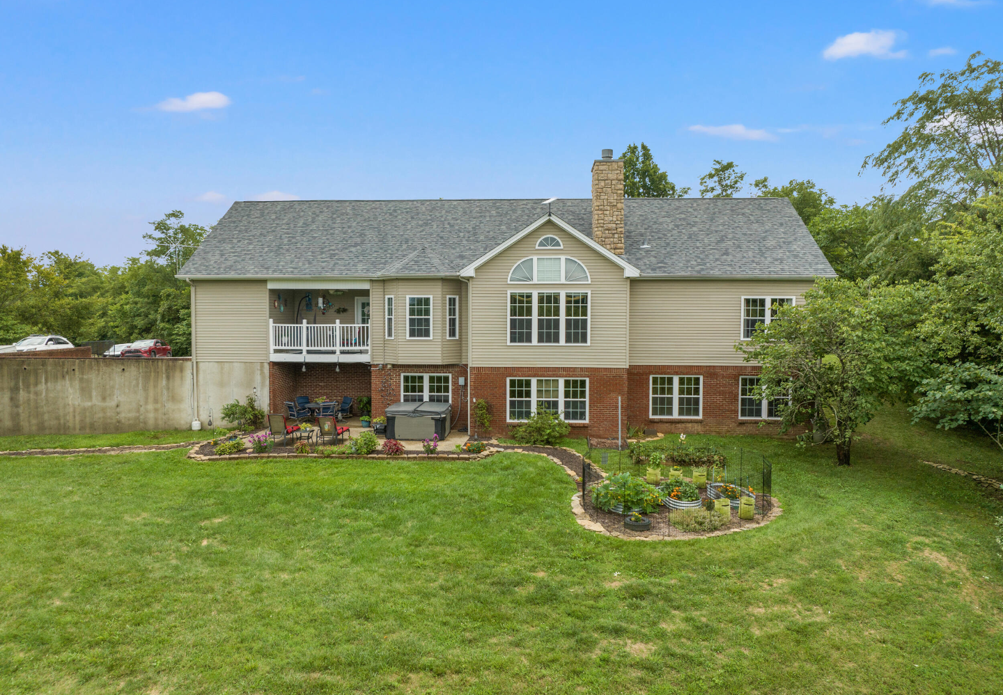A large house with a slate roof and two garages
