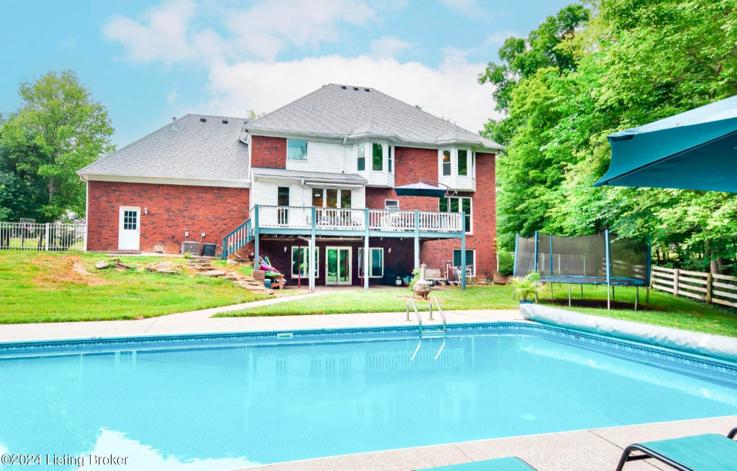 A living room with a couch , chairs , table and television.