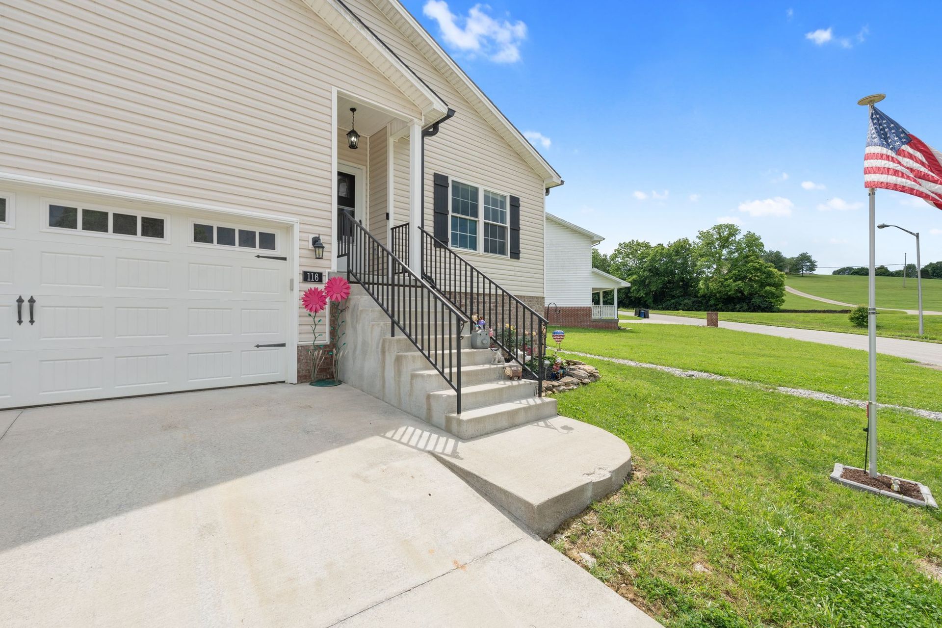 A kitchen with white cabinets and a large island in the middle.