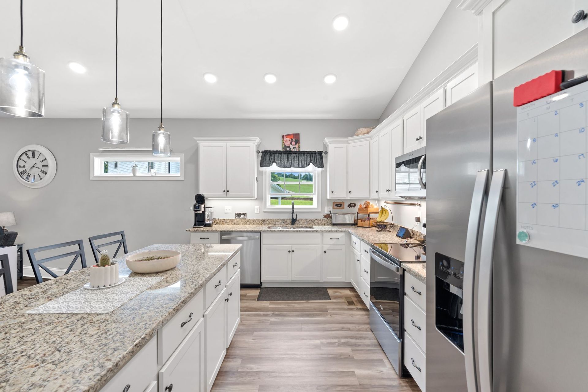 A living room with a couch , chair , table and rug.