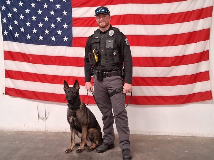 A man and a woman are standing in an empty room in a house.
