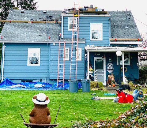 Contractors working on a roof installation in Olympia, WA