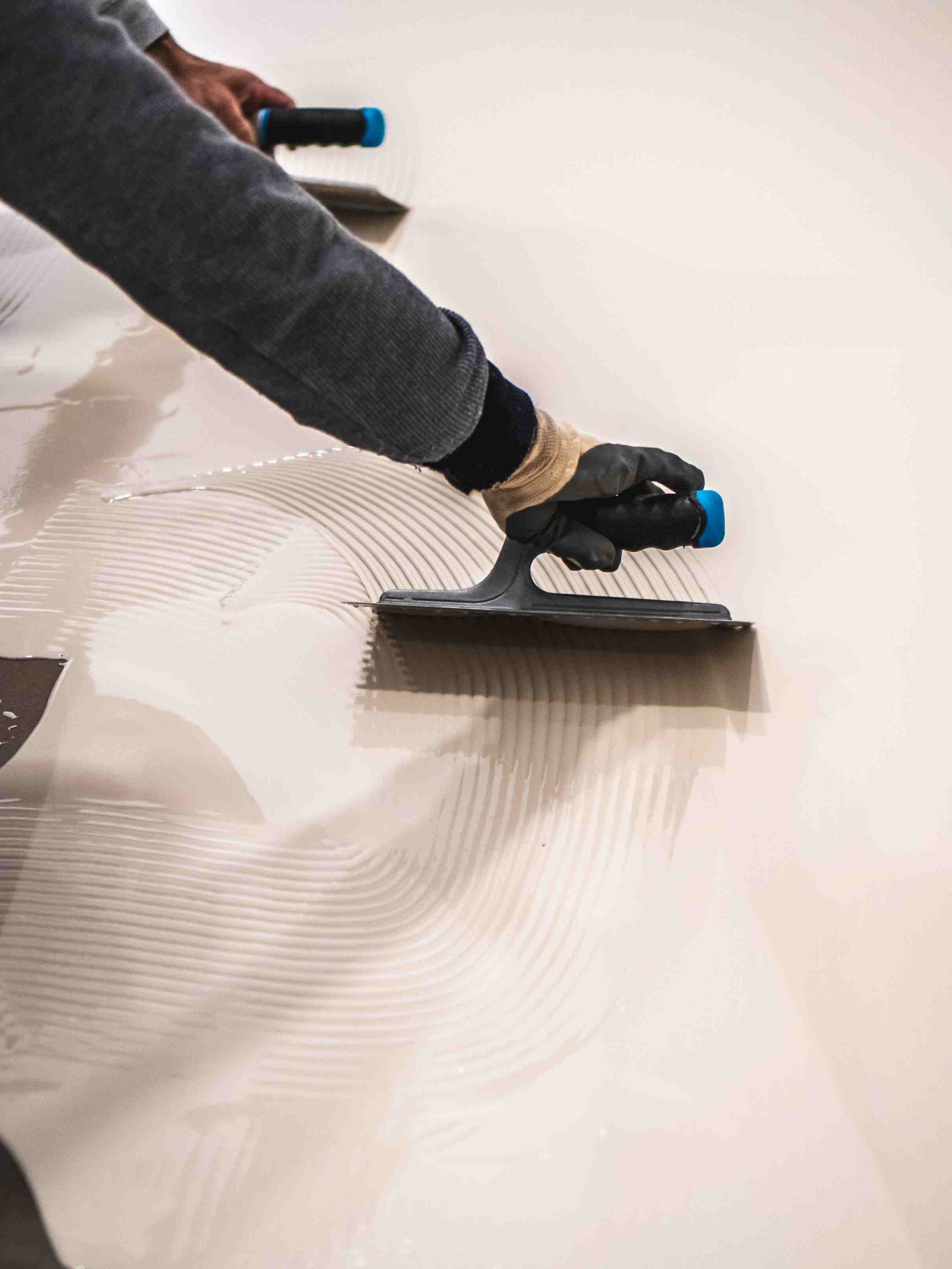 A worker applying coating to floors
