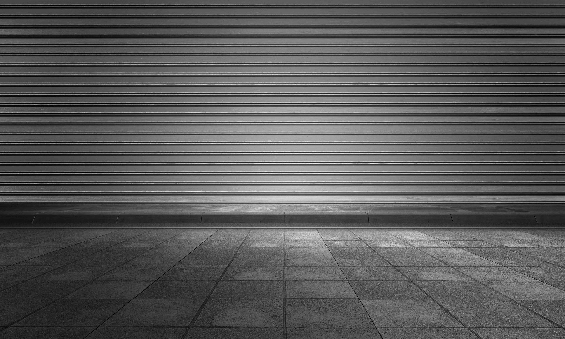 A photo of dark colored flooring in a dark room