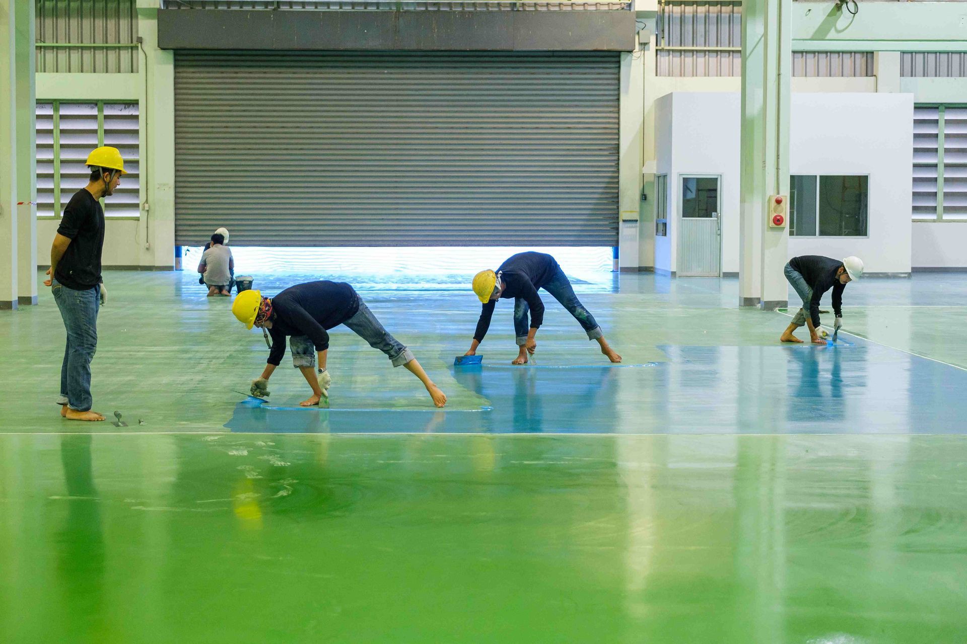 workers applying floor coating