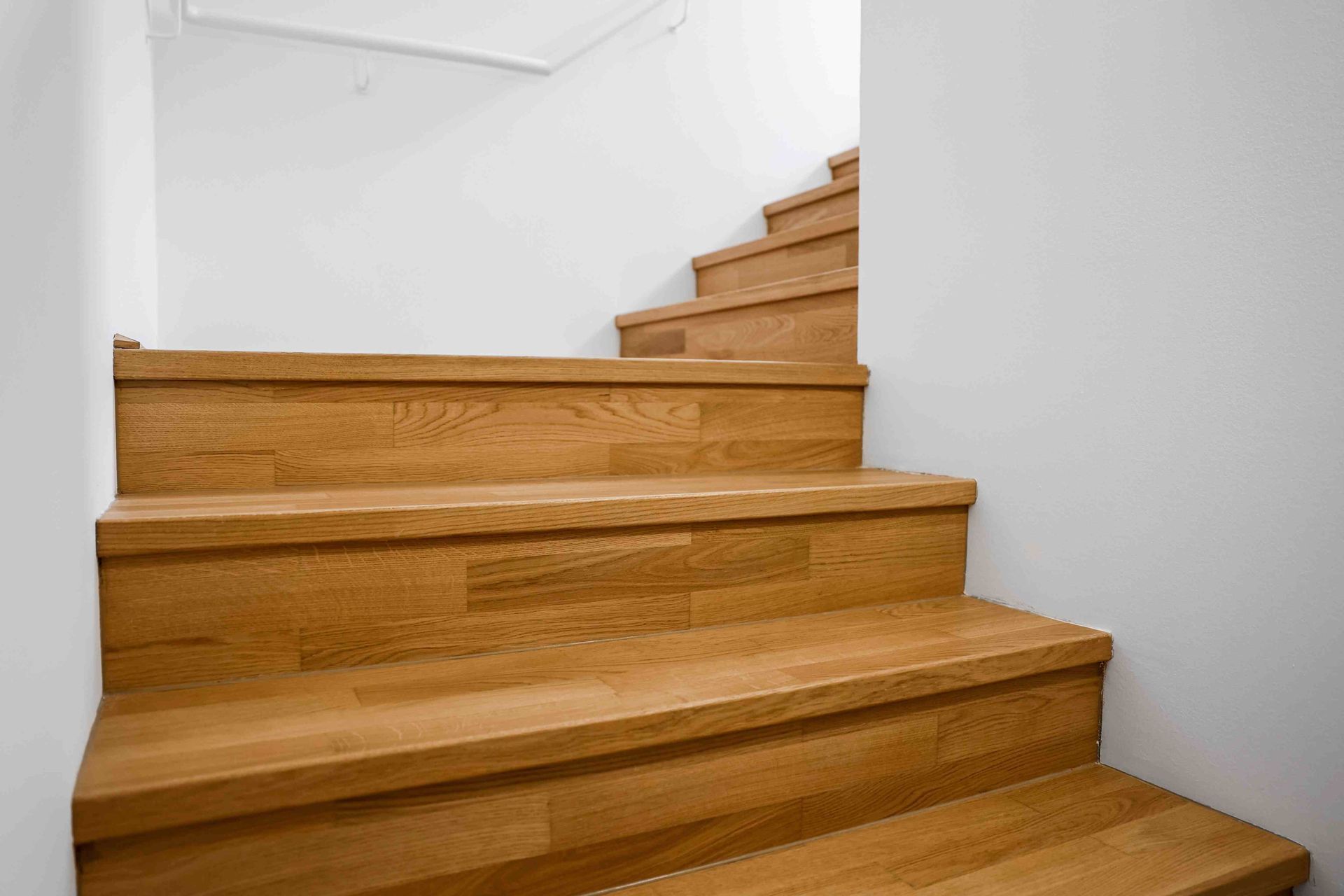 A man installing engineered hardwood flooring