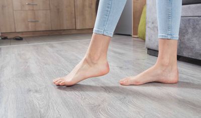 A woman walking on new flooring with bare feet