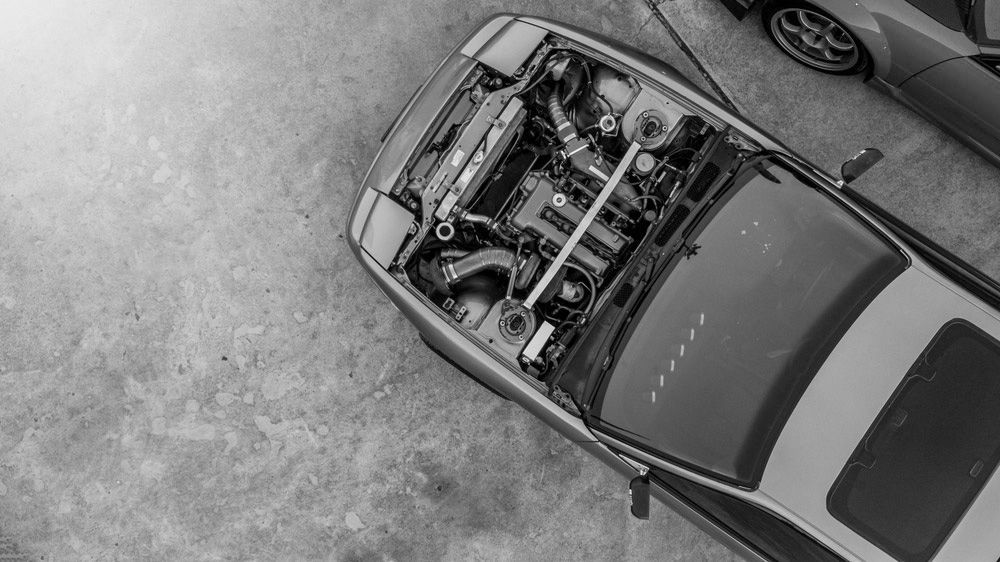 A Car With The Hood Open Is Parked Next To Another Car — Advanced Auto Tech In Port Macquarie, NSW