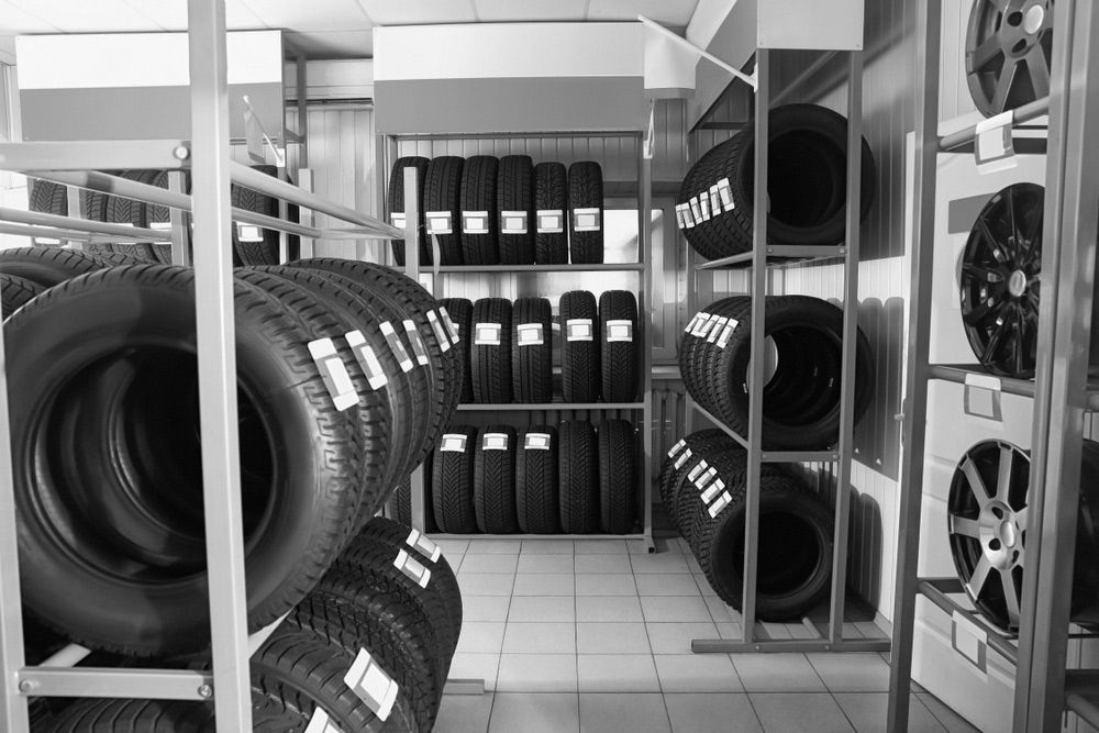 A Black And White Photo Of A Tire Store Filled With Lots Of Tires — Advanced Auto Tech In Port Macquarie, NSW