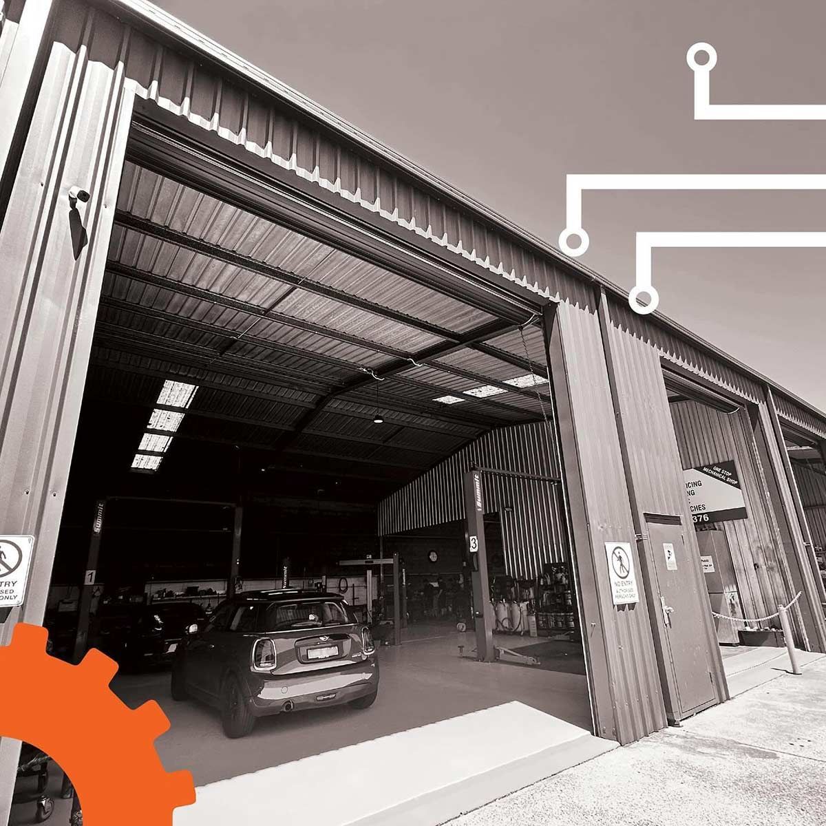 A Car Is Parked In A Garage With The Doors Open — Advanced Auto Tech In Port Macquarie, NSW