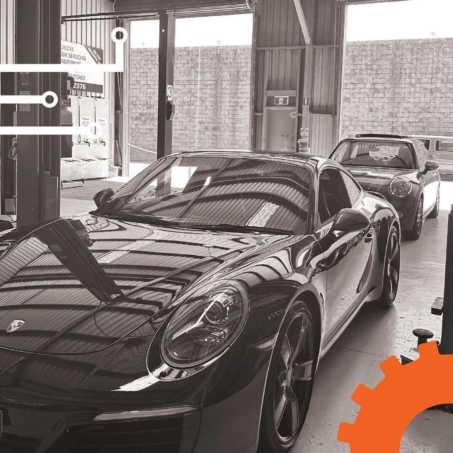 A Black And White Photo Of Two Sports Cars In A Garage — Advanced Auto Tech In Port Macquarie, NSW