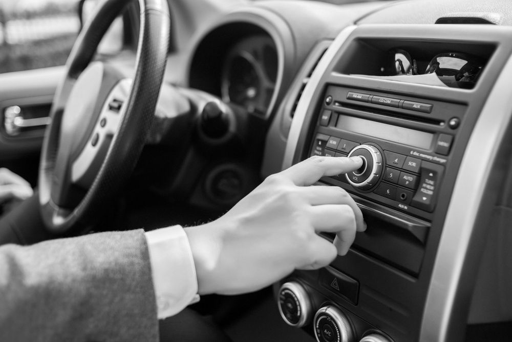 A Person Is Adjusting The Aircon In A Car — Advanced Auto Tech In Port Macquarie, NSW