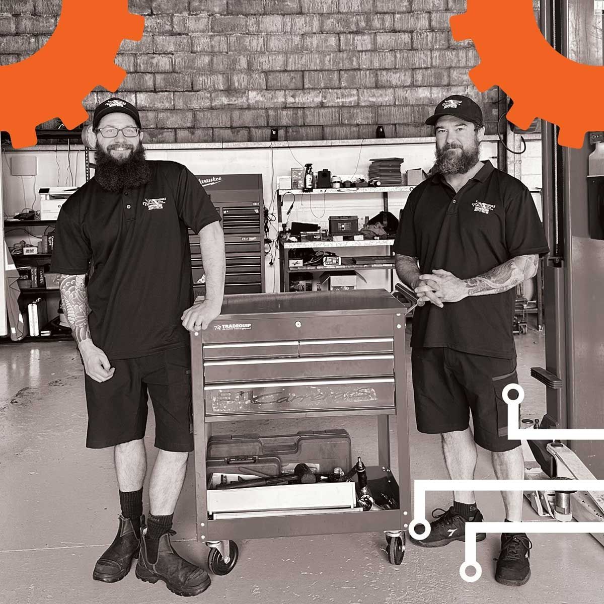 Two Men Are Standing Next To Each Other In A Garage — Advanced Auto Tech In Port Macquarie, NSW
