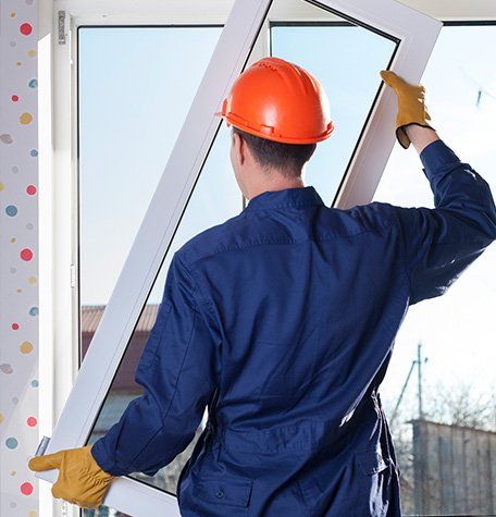 Man Holding New Window — Hendersonville, TN — Sumner Roofing & Exteriors