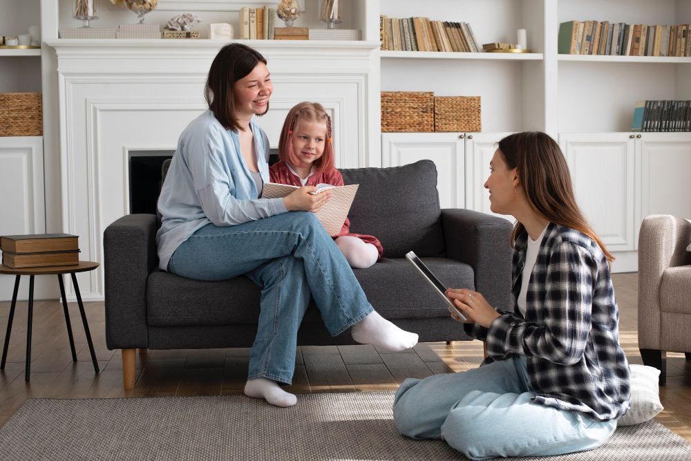 Therapist smiling and talking with child during ABA therapy session
