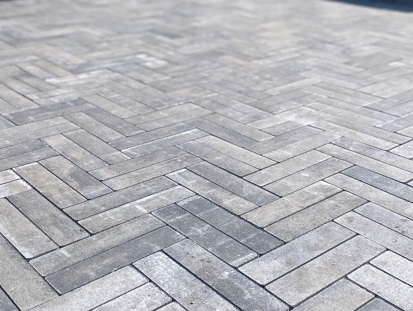 a close up of a brick pavement with a herringbone pattern